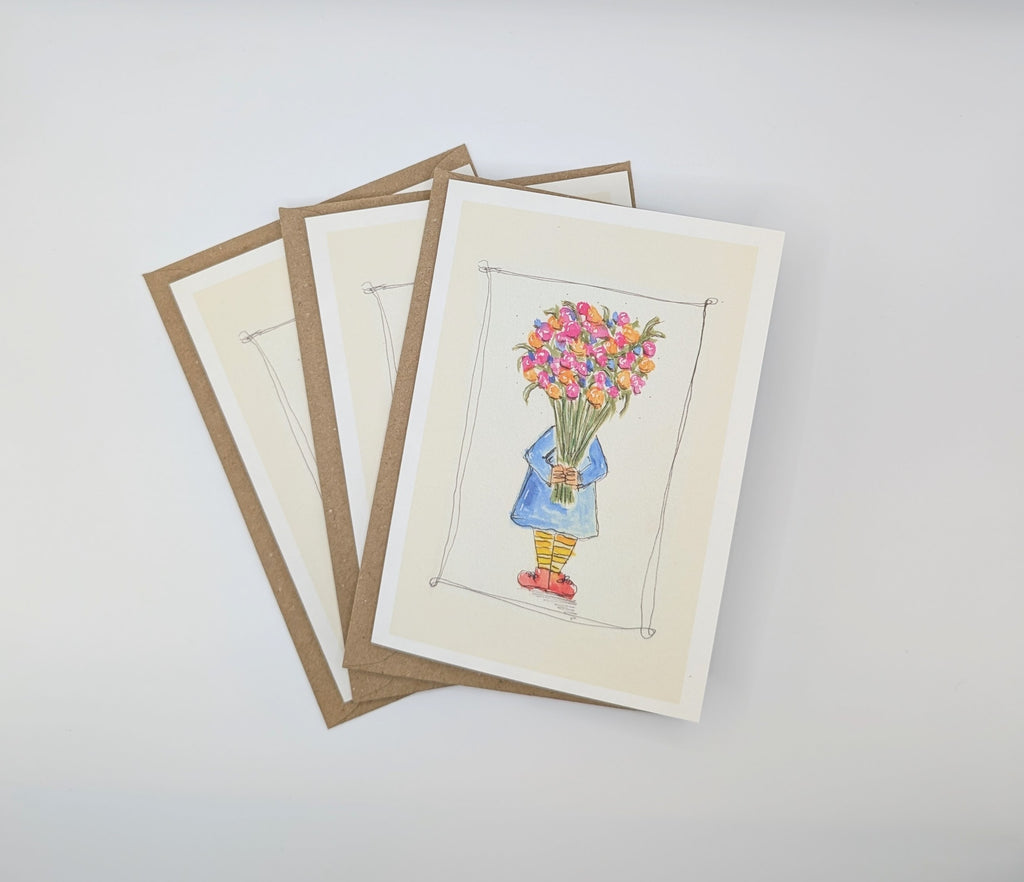 Hand-painted watercolour greeting card showing a small child in a blue coat and yellow stripy socks hidden behind a huge bouquet of blabberberries, with an ink border